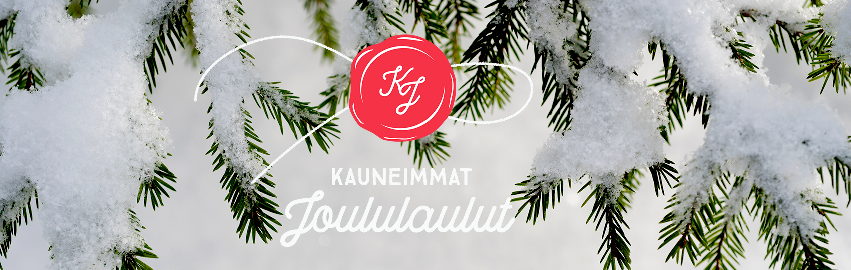 Lumisia kuusenoksia, joiden päällä Kauneimpien Joululaulujen logo.